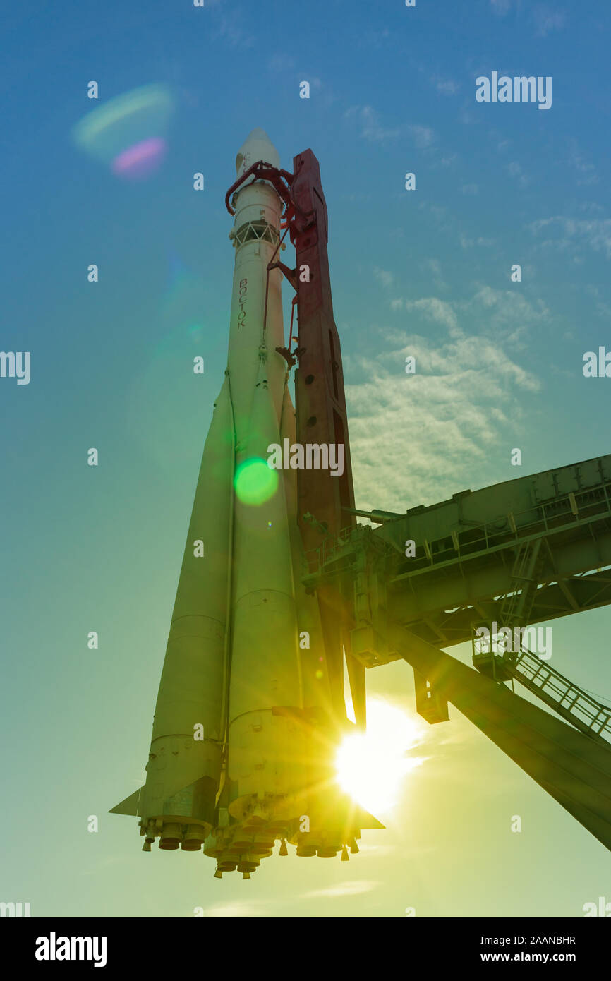 Russian space rocket Vostok at launching platform, Sun lens flare, optical effect with color toning Stock Photo
