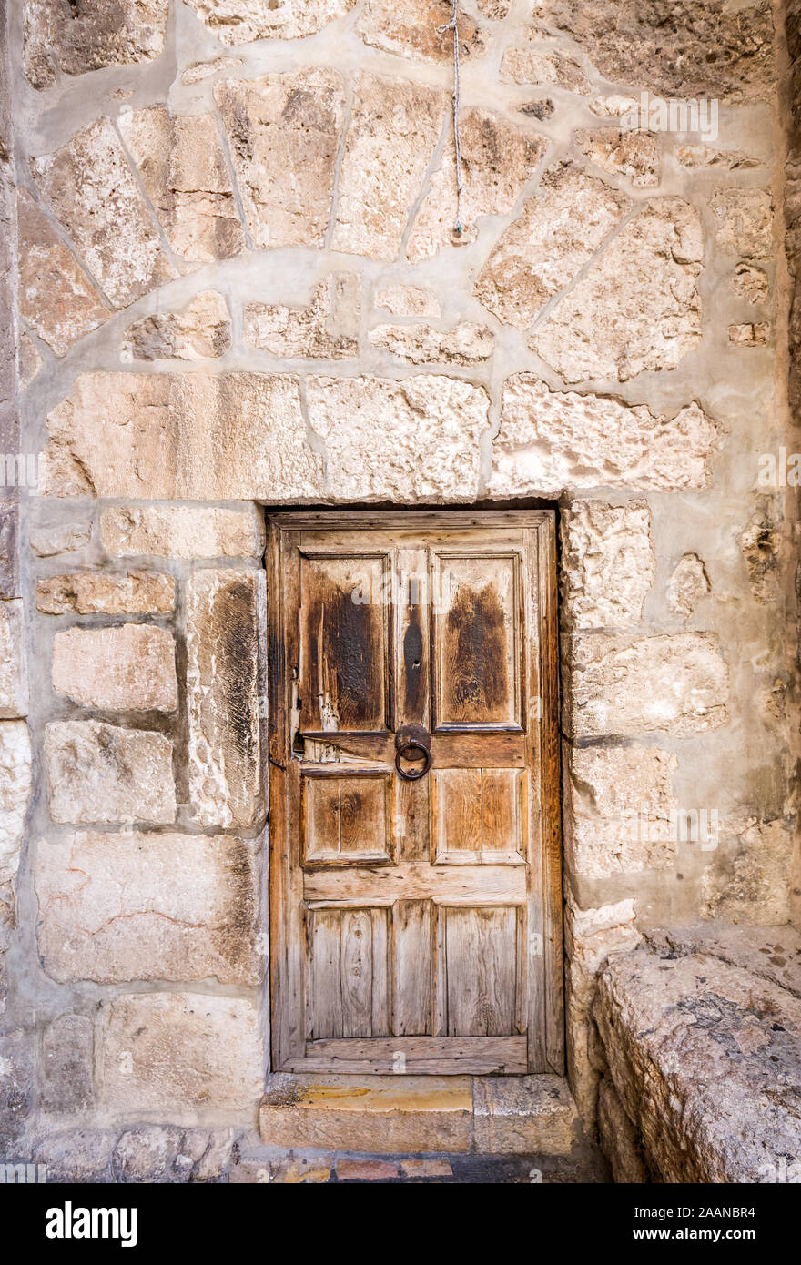 Ancient wooden door and stone walls in Jerusalem, Israel. Stock Photo
