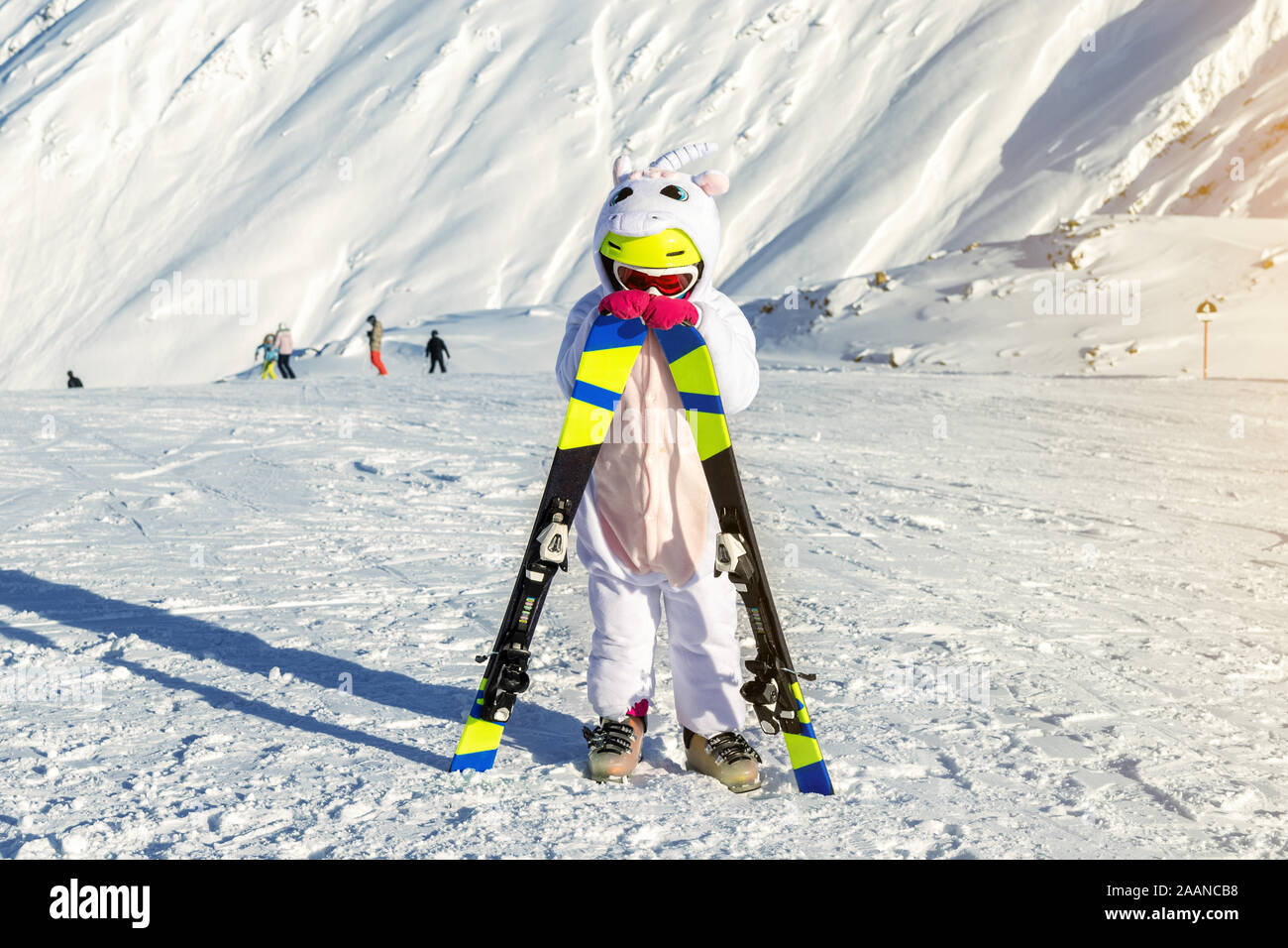 Sad adorable preschooler caucasian tired kid girl resting leaning on ski in  helmet, goggles and unicorn fun costume enjoy winter sport activities Stock  Photo - Alamy