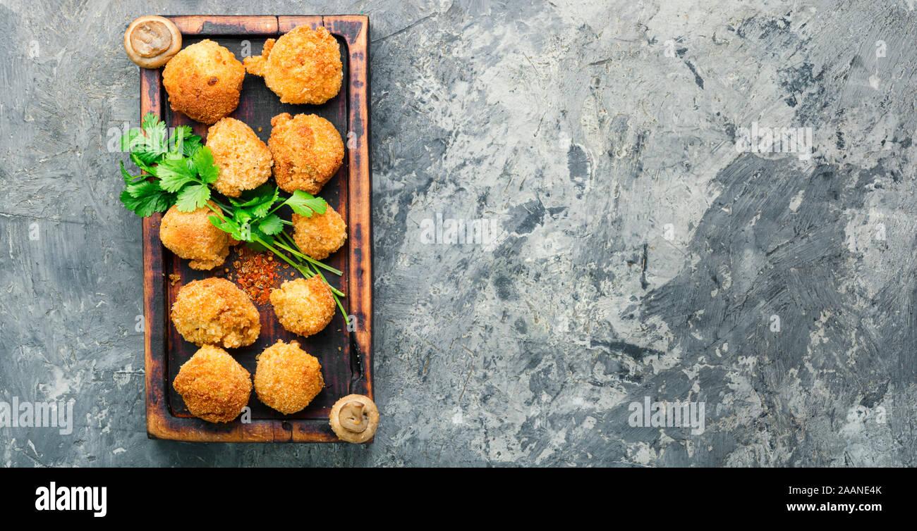 Champignon mushrooms in breadcrumbs.Breaded mushrooms or deepfried