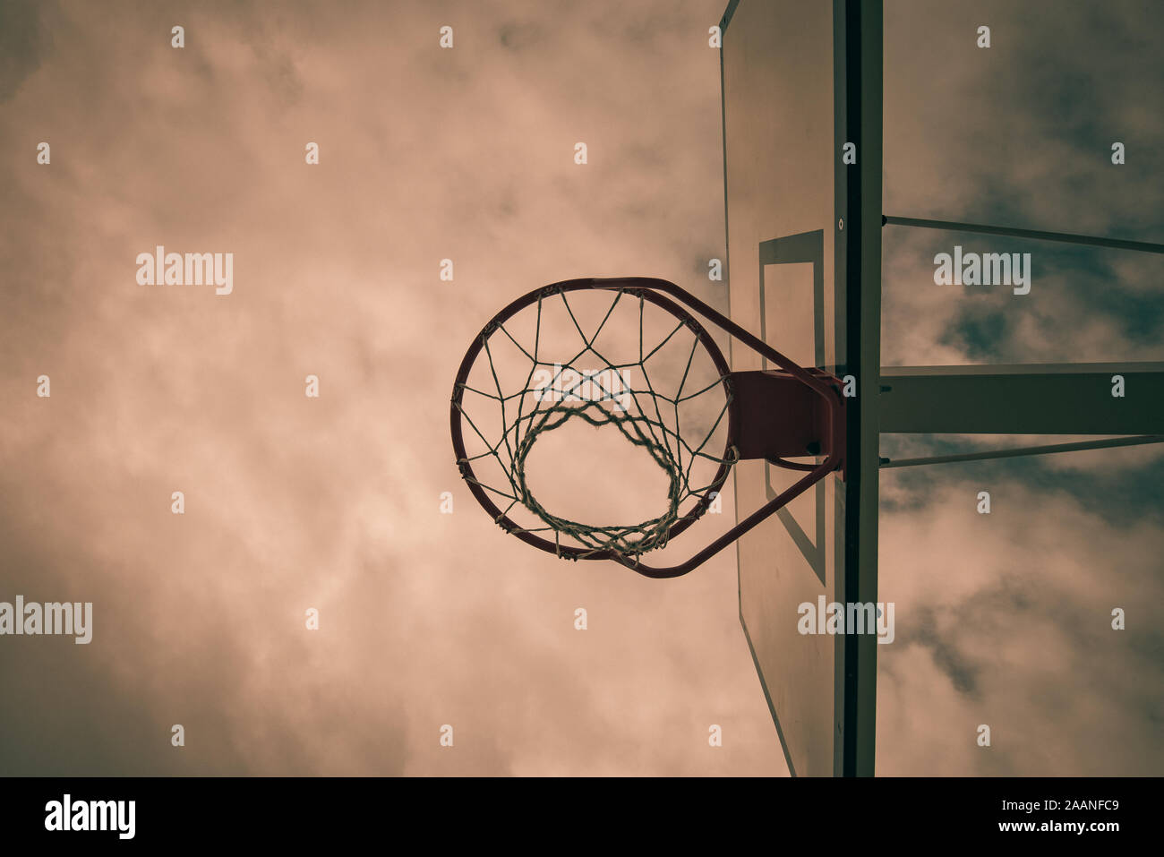 basketball hoop in a community park waiting for the storm to start with