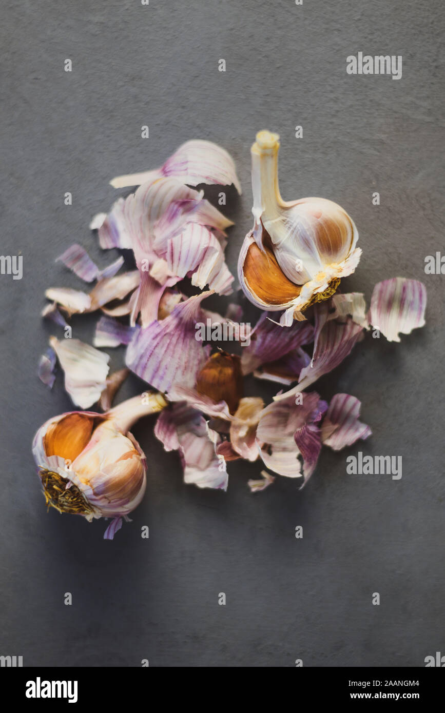 Garlic bulbs with cloves and peels on grey background Stock Photo - Alamy