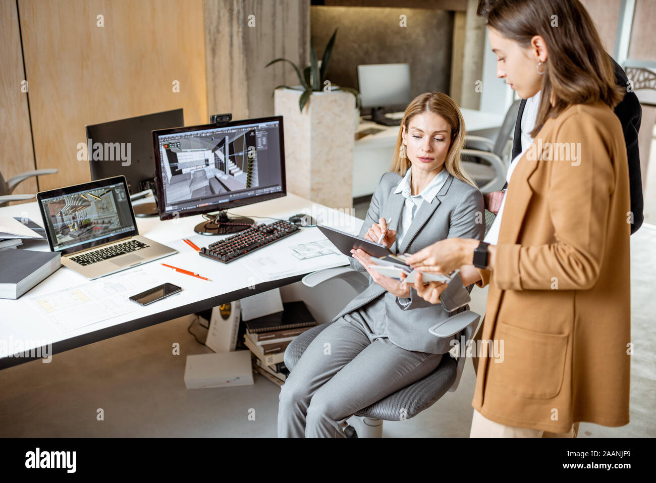 Strictly dressed office employees working with digital tablet and