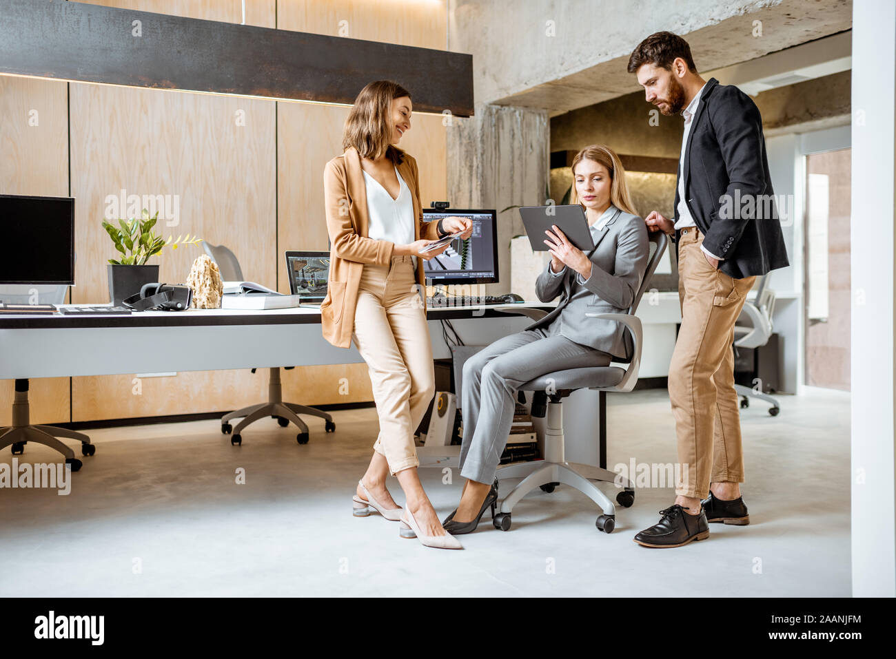 Strictly dressed office employees working with digital tablet and