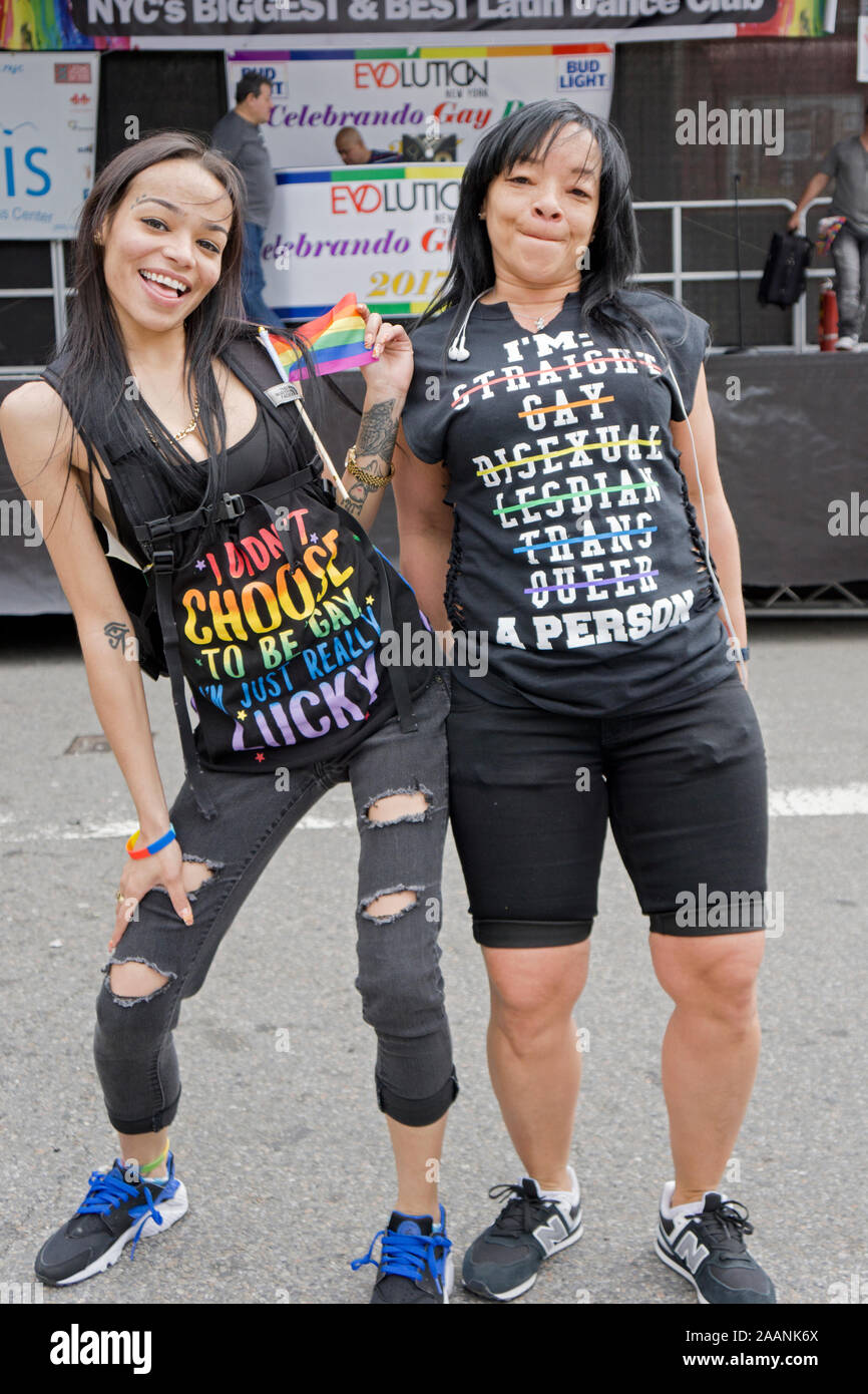 Two gay women with expressive t shirts at the Queens Pride Parade in Jackson Heights, New York City. Stock Photo
