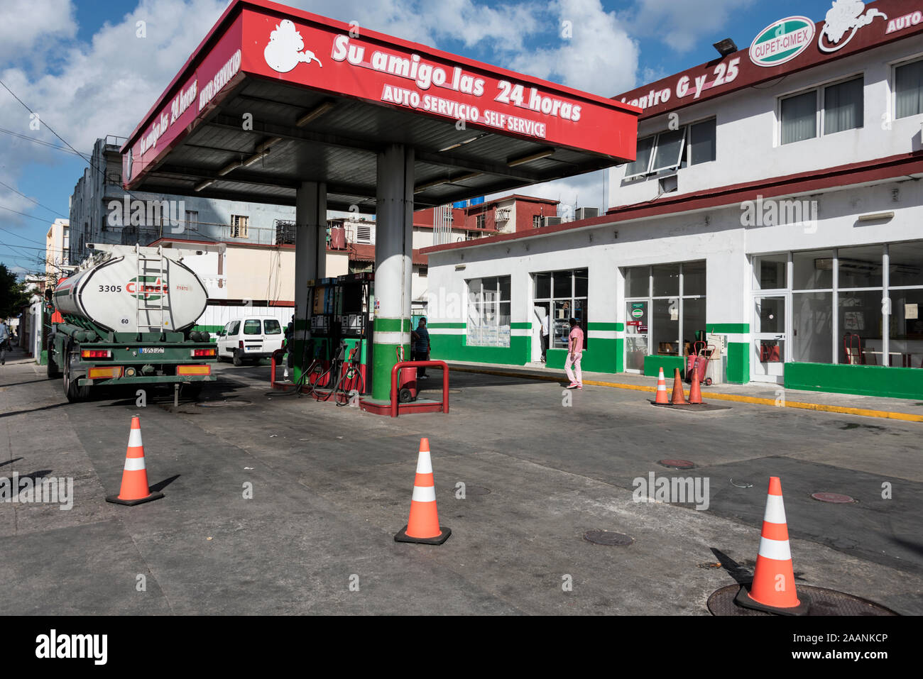 A petrol tanker delivering fuel to one of its garage outlets in Havana, Cuba.   The Cuba Oil Union ( Unión Cuba-Petróleo) -CUPET is Cuba's largest oil Stock Photo