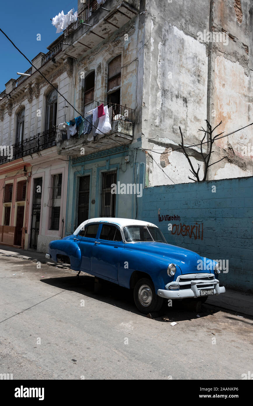 An American classic saloon car jacked up in a side street in Havana