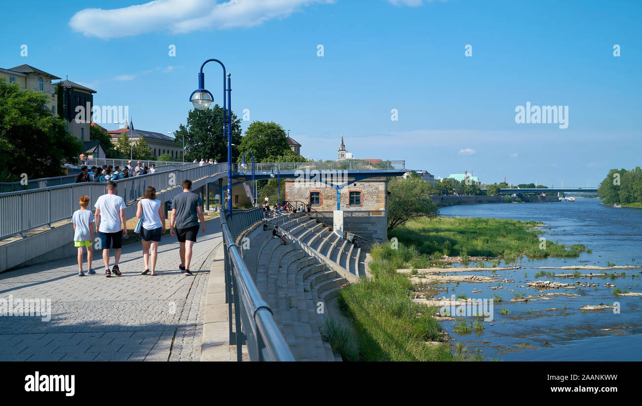 Walkers on a promenade along the river Elbe near Magdeburg Stock Photo