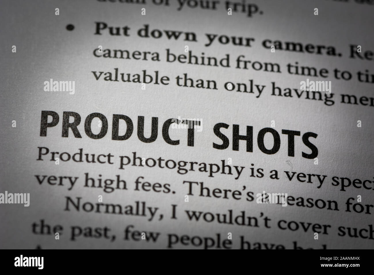 Macro photograph of words 'product shots' in white page of a book about photography with small vignette applied. Stock Photo