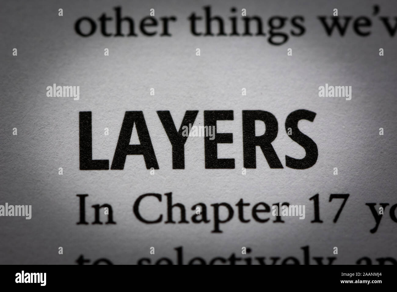 Macro photograph of word 'Layers' in white page of a book about photography with small vignette applied. Stock Photo
