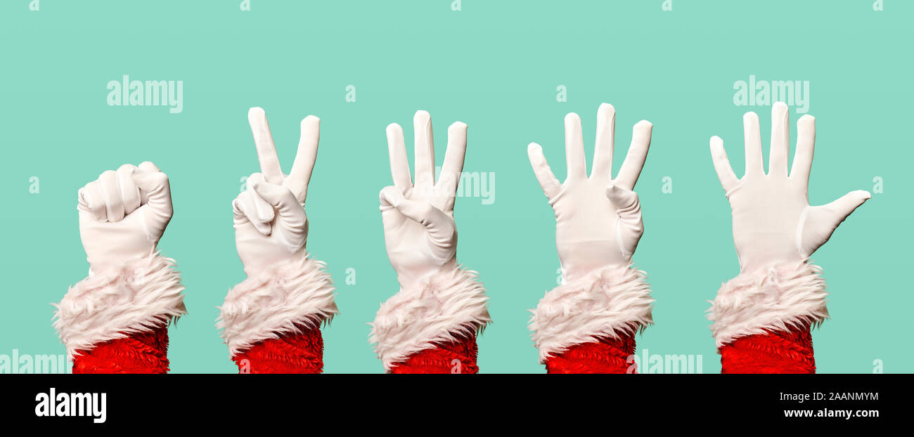 Five Santa Claus hands in white gloves on blank blue background