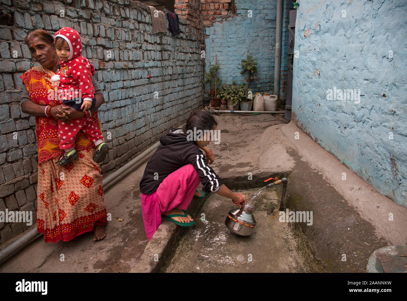 (191123) -- NEW DELHI, Nov. 23, 2019 (Xinhua) -- A woman gets drinking water from a tap with a container in New Delhi, India, Nov. 23, 2019. Days after India's federal government rankings on tap water showed samples taken from the capital city Delhi have failed on all parameters, the local authorities Wednesday said it would collect over 3,000 fresh samples from across the city for quality check. The federal government's consumer affairs ministry last week said 11 drinking water samples drawn from various places in Delhi did not comply with the requirements of the Bureau of Indian Standard a Stock Photo