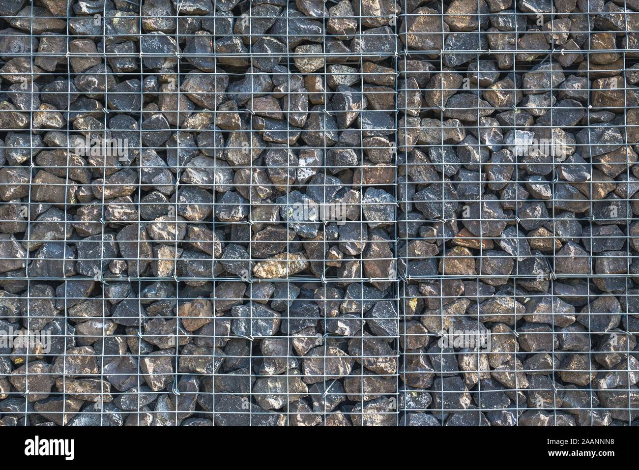 Wire Gabion Rock Fence. Metal Cage filled with rocks. Texture