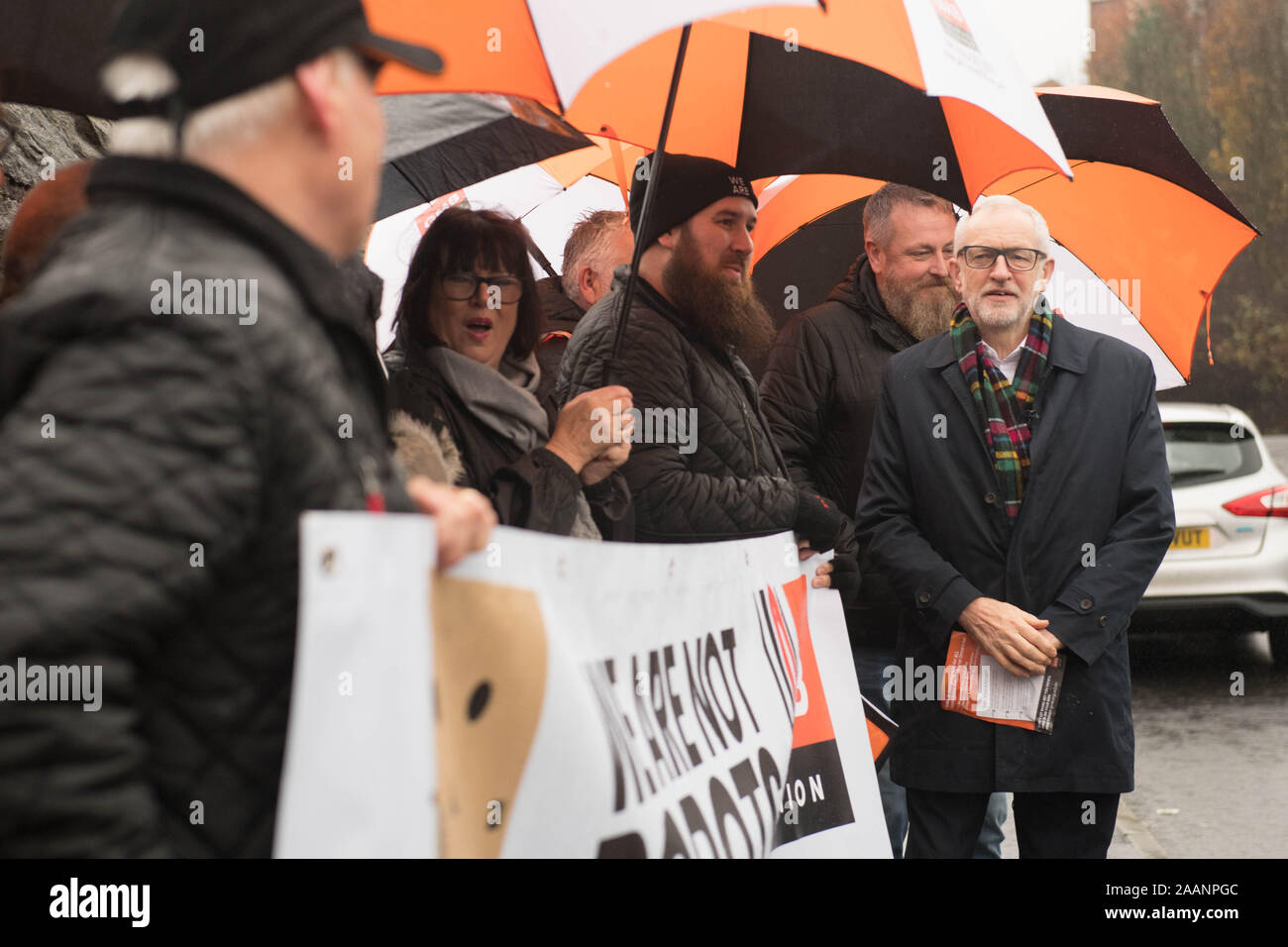 Labour Party leader Jeremy Corbyn (right)outside an Amazon depot in Sheffield, South Yorkshire, to announce plans for a workers' rights revolution and to ensure big businesses pay their fair share of taxes. Stock Photo