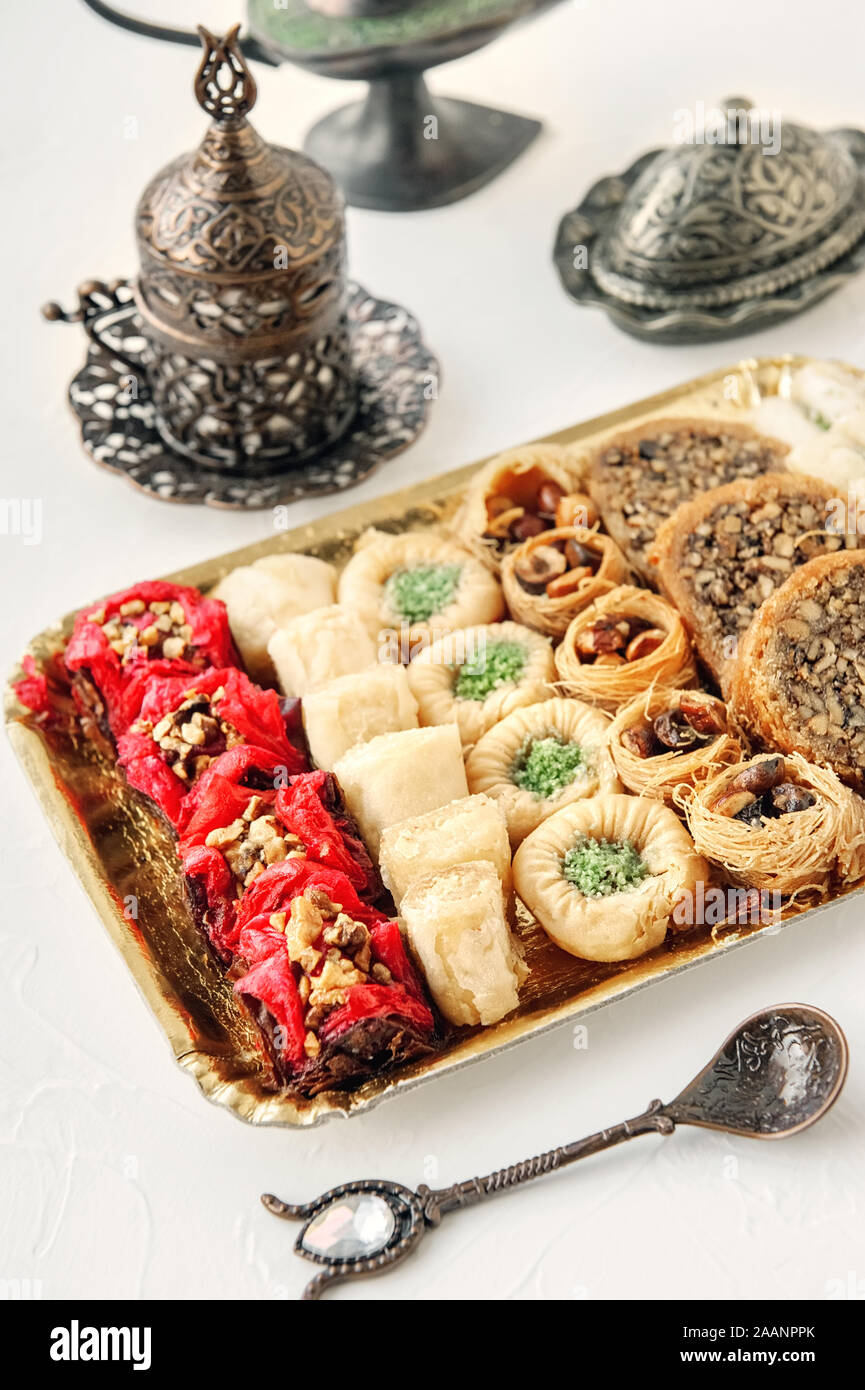 Eid Mubarak with Arabic sweets. Dried dates and tea in Arabic glasses ...