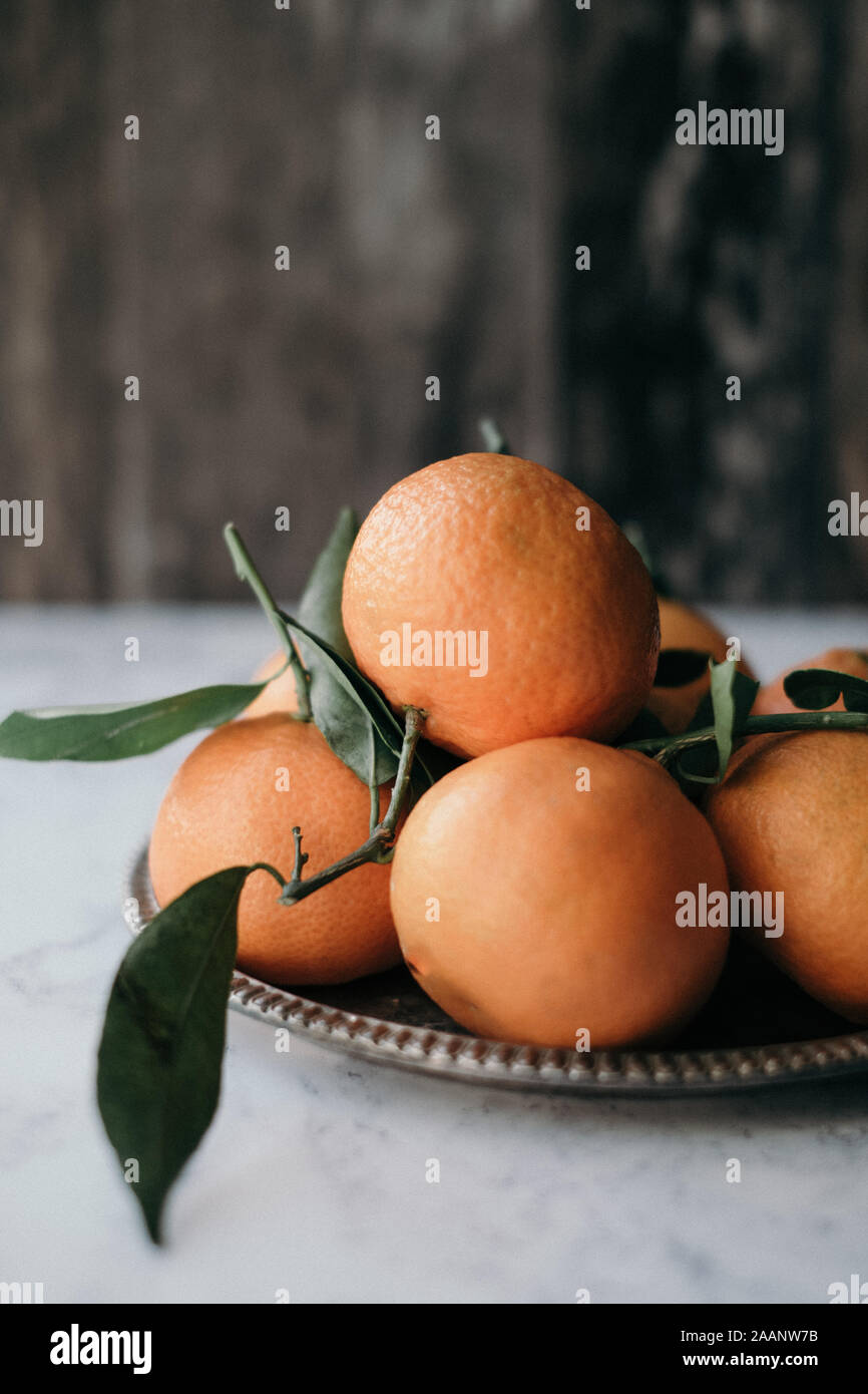 Clementines styled with their green leaves and stalks Stock Photo Alamy