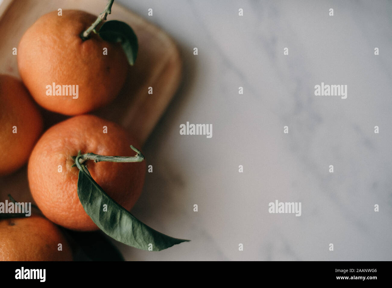 Clementines styled with their green leaves and stalks Stock Photo Alamy