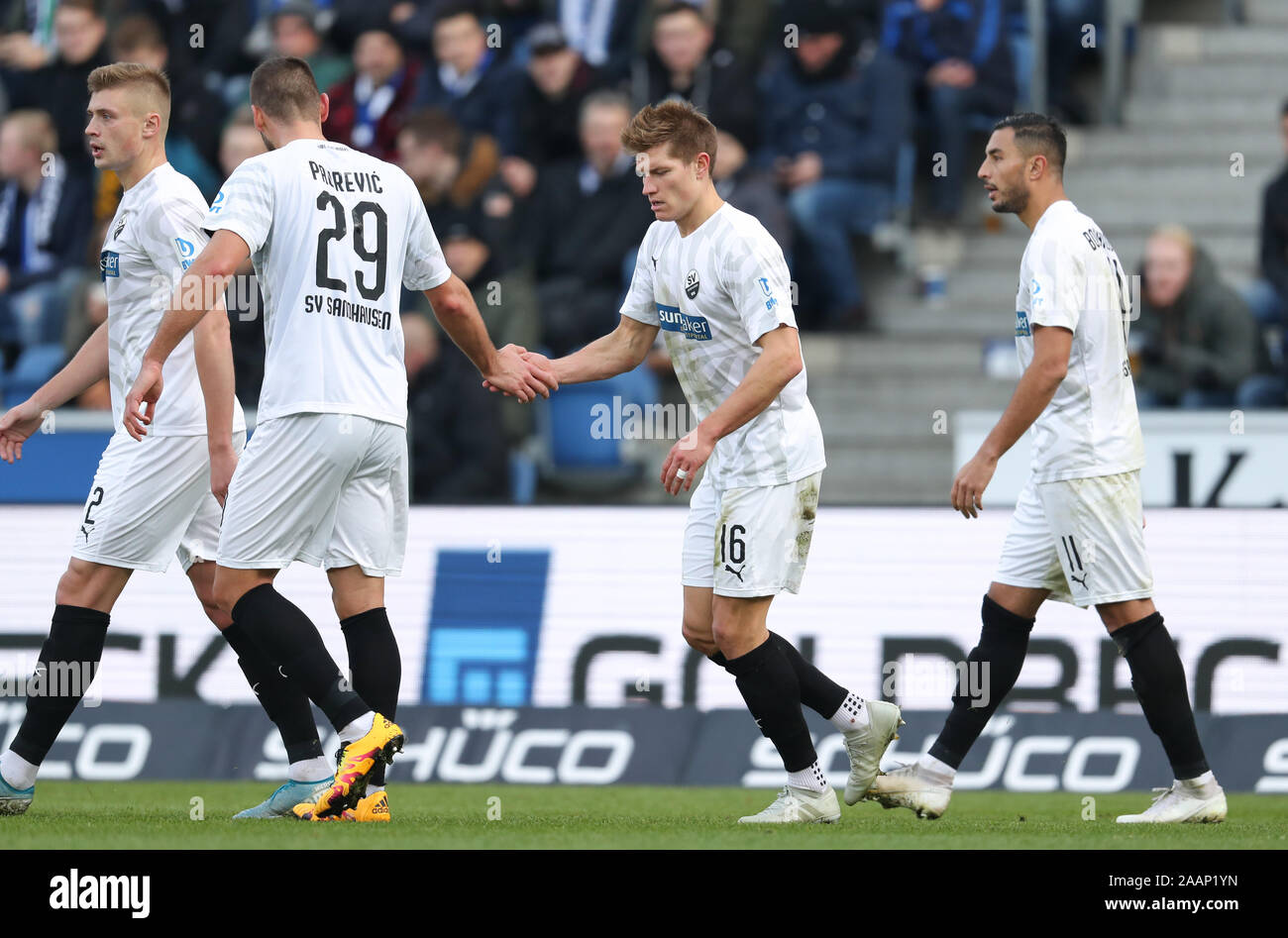 Bielefeld, Germany. 23rd Nov, 2019. Soccer: 2nd Bundesliga, Arminia Bielefeld - SV Sandhausen, 14th matchday in the Schüco Arena. Scorer Kevin Behrens (M) from Sandhausen celebrates his 1-1 goal with Ivan Paurevic (2nd from left) and Aziz Bouhaddouz (r). Credit: Friso Gentsch/dpa - IMPORTANT NOTE: In accordance with the requirements of the DFL Deutsche Fußball Liga or the DFB Deutscher Fußball-Bund, it is prohibited to use or have used photographs taken in the stadium and/or the match in the form of sequence images and/or video-like photo sequences./dpa/Alamy Live News Stock Photo