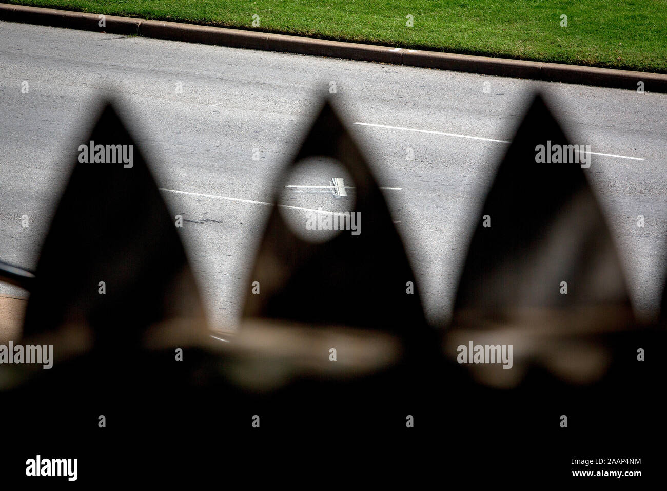 The view from behind the wooden fence on Grassy Knoll at the Dealey Plaza. According to conspiracy theories, a shot was fired from this position during the JFK assassination of US President John f. Kennedy in Dallas. The spot behind the fence has a perfect view on the spot where the fatal shot hit the President. Stock Photo