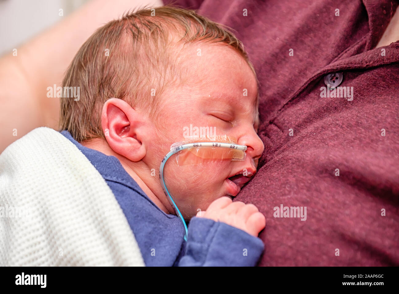 Premature Baby Boy Infant With Nasogastric Ng Tube Being Cared For By Parents In A Hospital Setting Being Held By Father Stock Photo Alamy