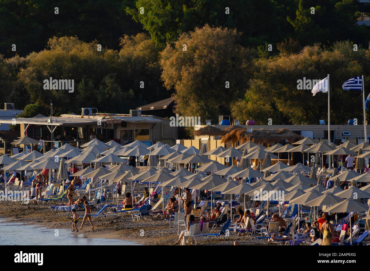 People relax on the beach at Vouliagmeni on the Athenian Riviera in Athens Greece Stock Photo