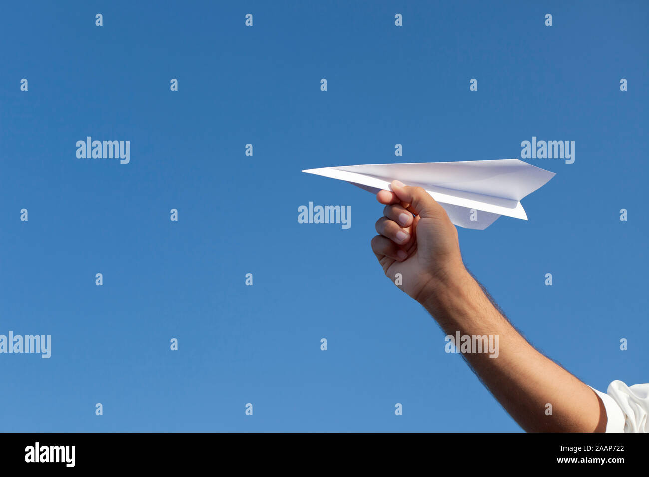 Person holding paper airplane Stock Photo
