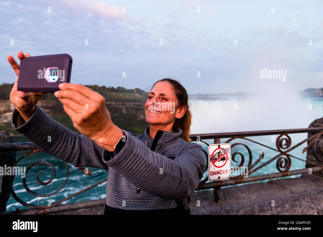 Tourist takes selfie while on vacation, at Niagara Falls Stock Photo