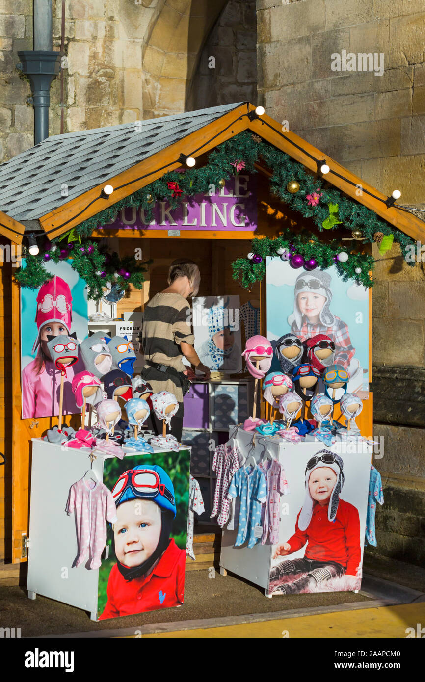 My Little Duckling market stall selling cute baby hats and baby clothes at Winchester Christmas Market, Winchester, Hampshire, UK in December Stock Photo
