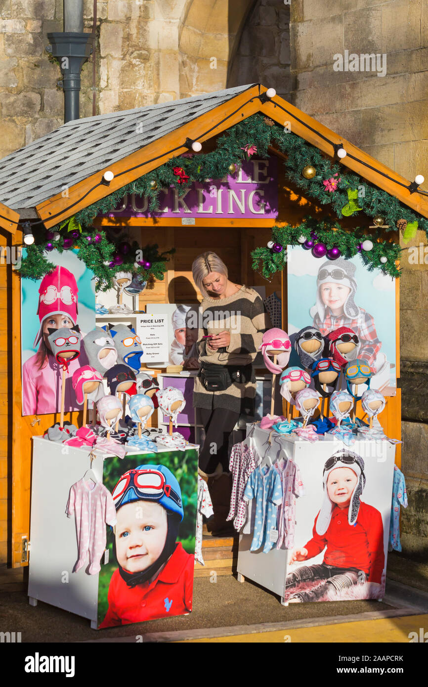 My Little Duckling market stall selling cute baby hats and baby toddler clothes at Winchester Christmas Market, Winchester, Hampshire, UK in December Stock Photo