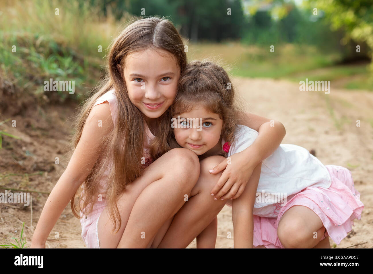 Portrait Of Two Cute Little Girls Embracing And Laughing At The Forest Happy Kids Outdoors Stock Photo Alamy Portrait Of Two Cute Little Girls Embracing And Laughing At The Forest Happy Kids Outdoors Stock Photo Alamy