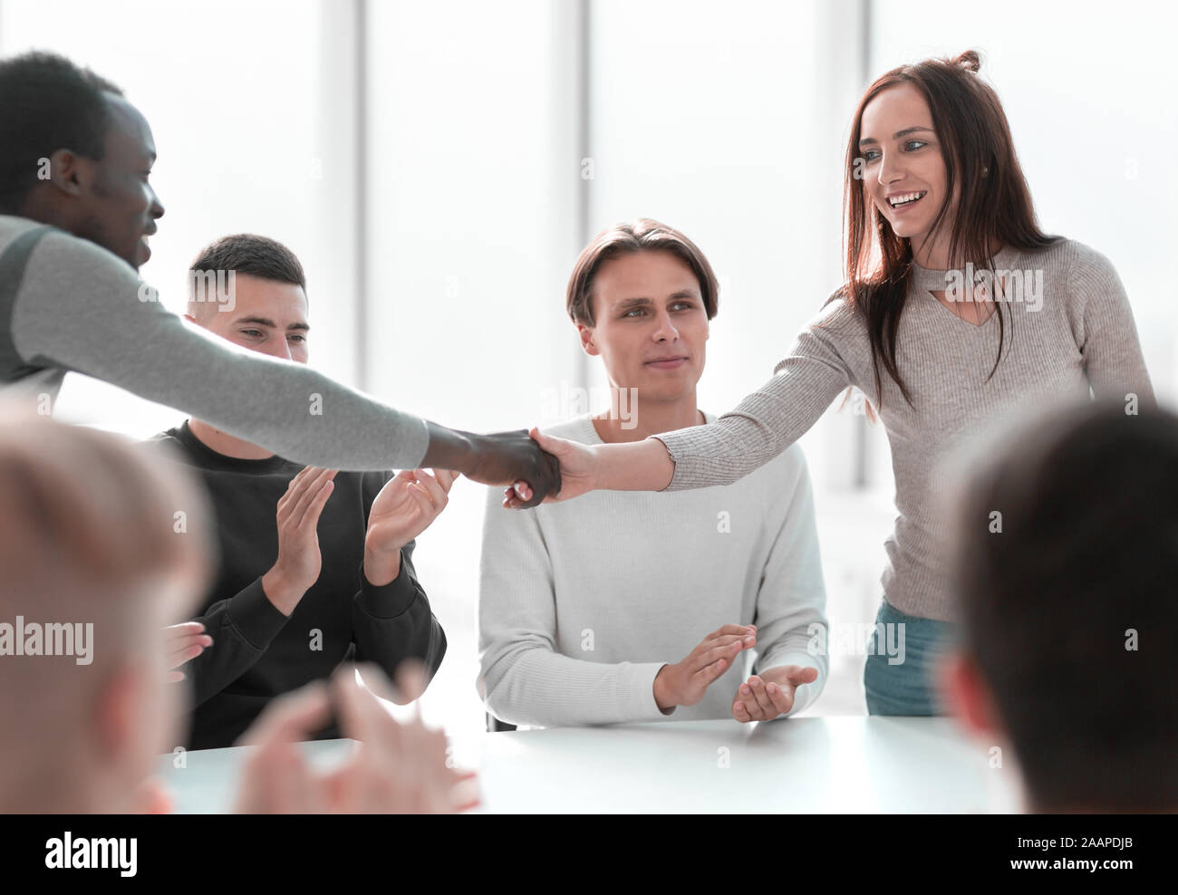 young people greet each other at a group meeting Stock Photo