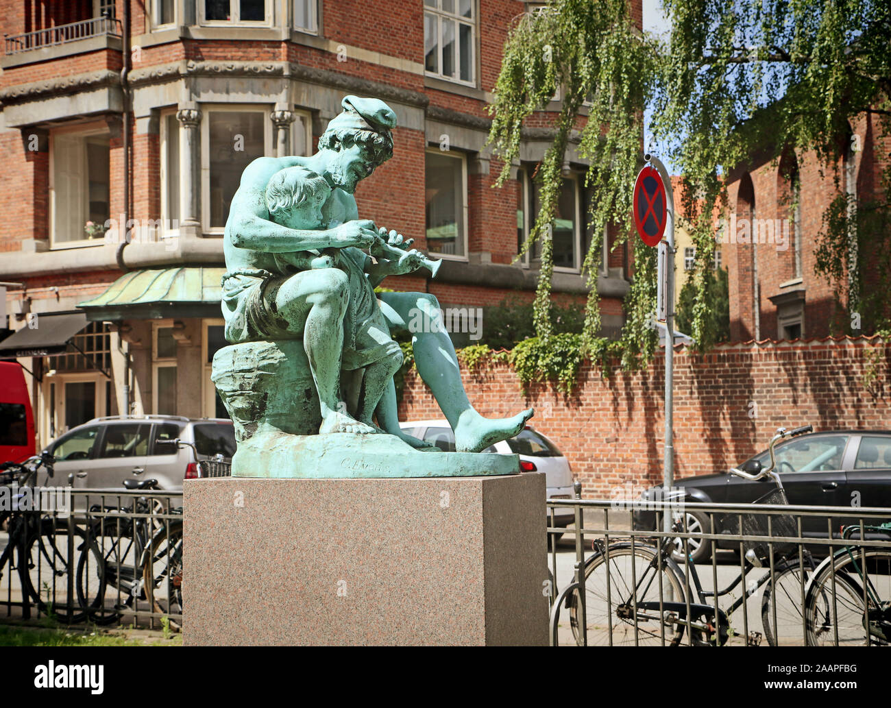 Bronze Statue of Neapolitan fisherman teaching his son to play the flute, made in 1859 by Otto Evens (1836-1895), at  Store Strandstræde, Copenhagen, Stock Photo