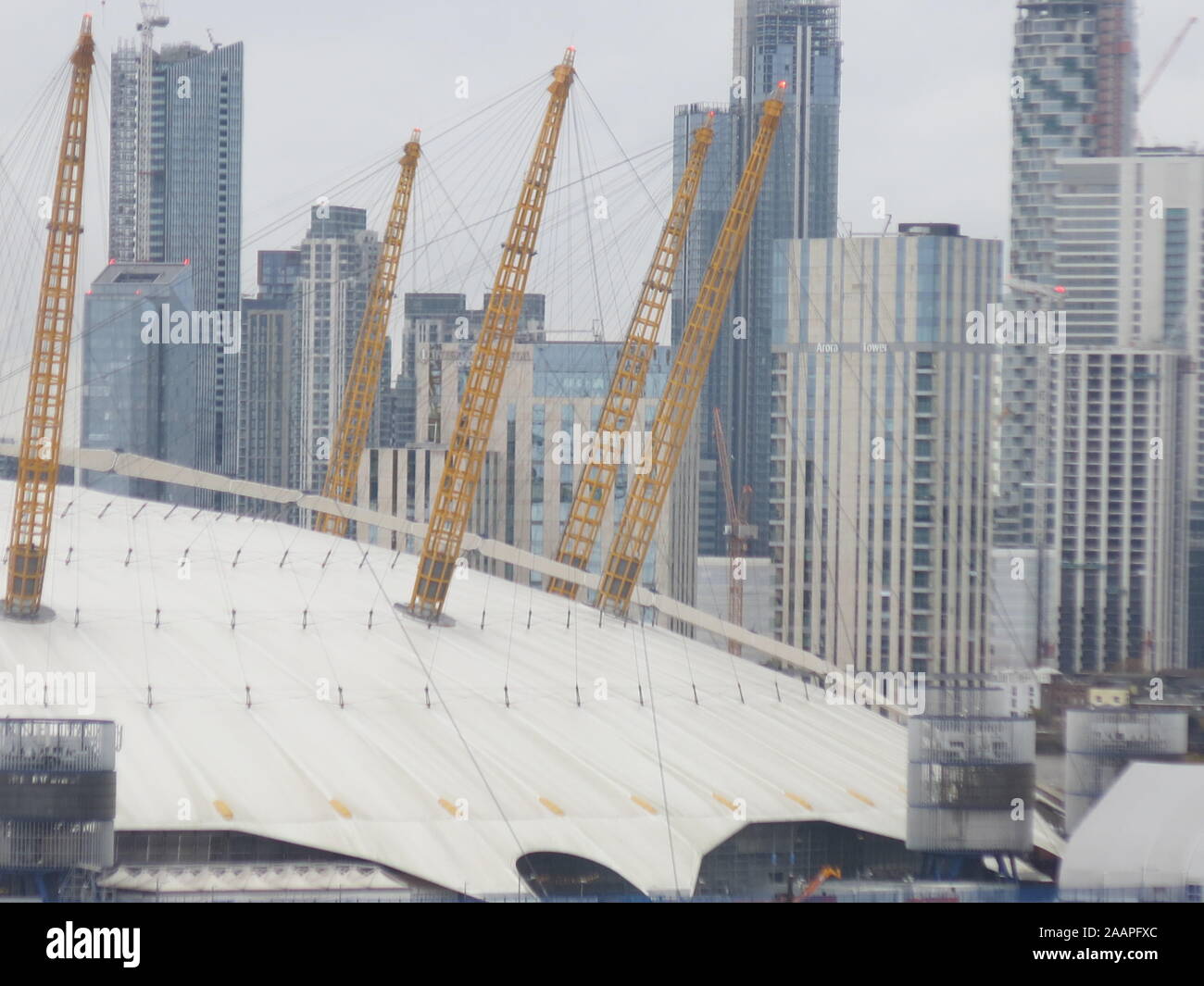The structural yellow pylons of the O2 arena roof stand out against the