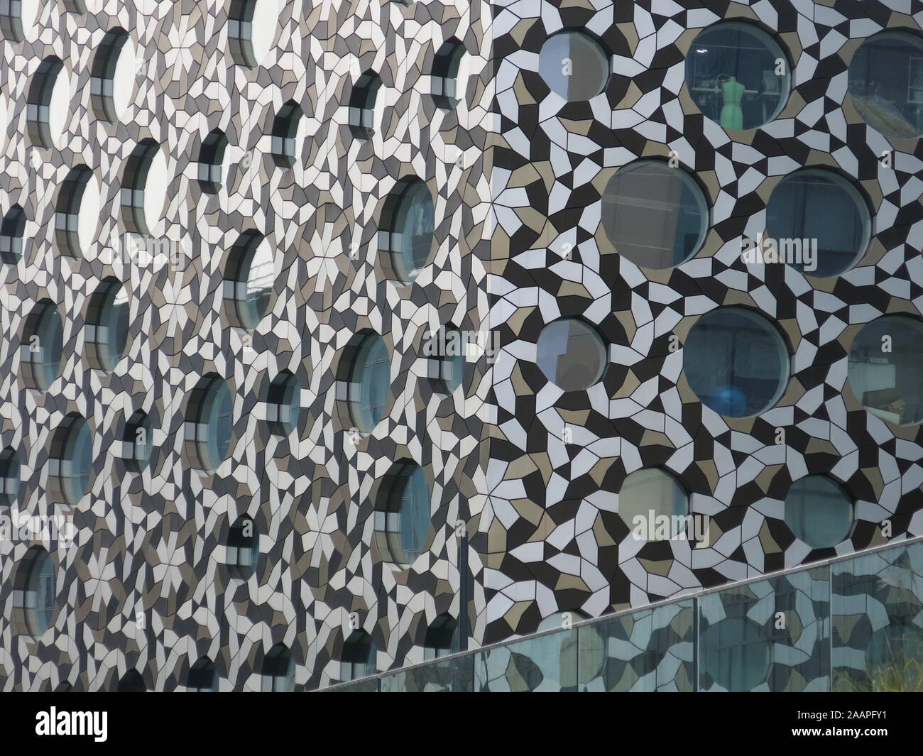 Façade of an eye-catching building at Greenwich, with circular windows and an abstract geometric pattern on the exterior cladding. Stock Photo