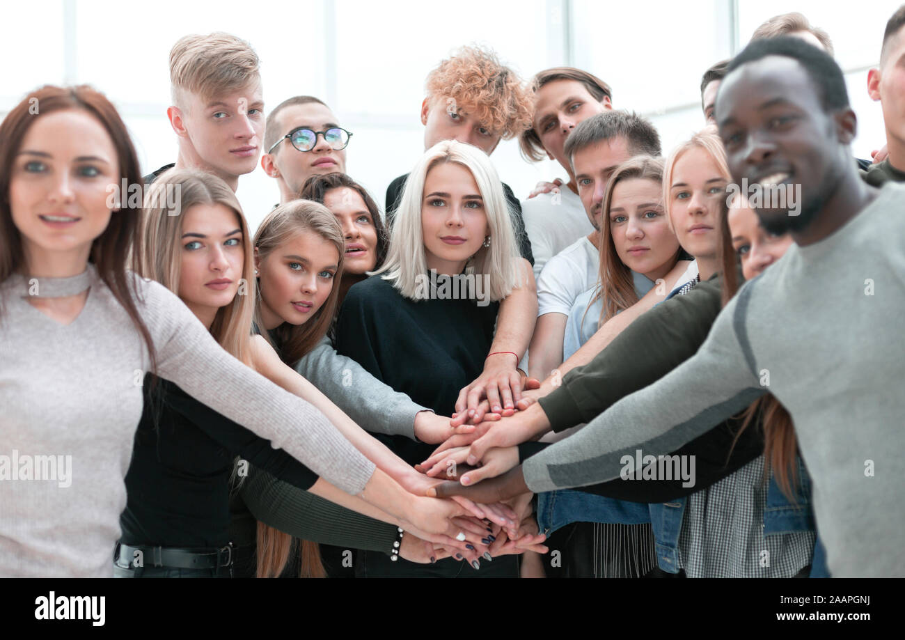 diverse young people putting their hands together Stock Photo - Alamy