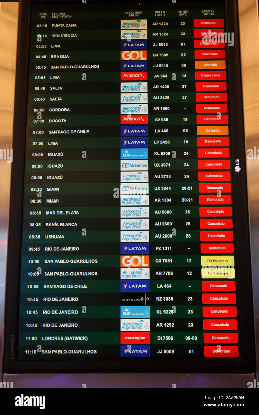Flight check-in information board showing cancelled and delayed flights in red. Cancelado, demorado. Spanish language. Stock Photo