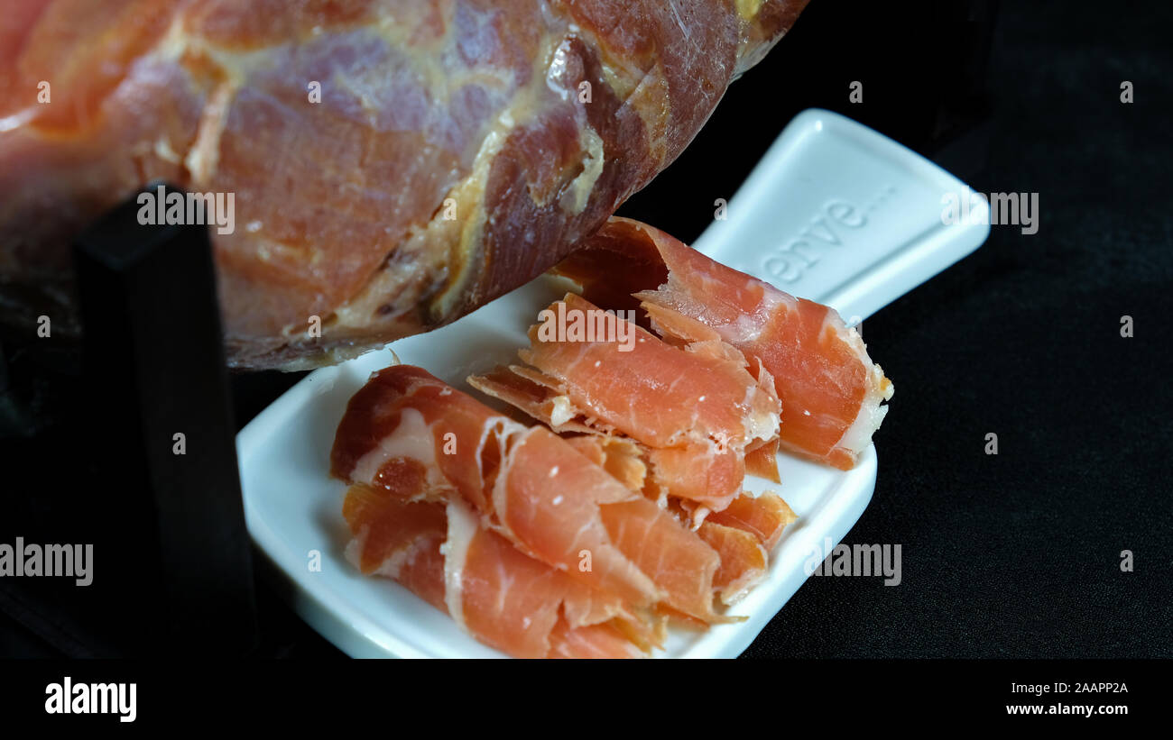 Pieces of jamon on a white plate Stock Photo