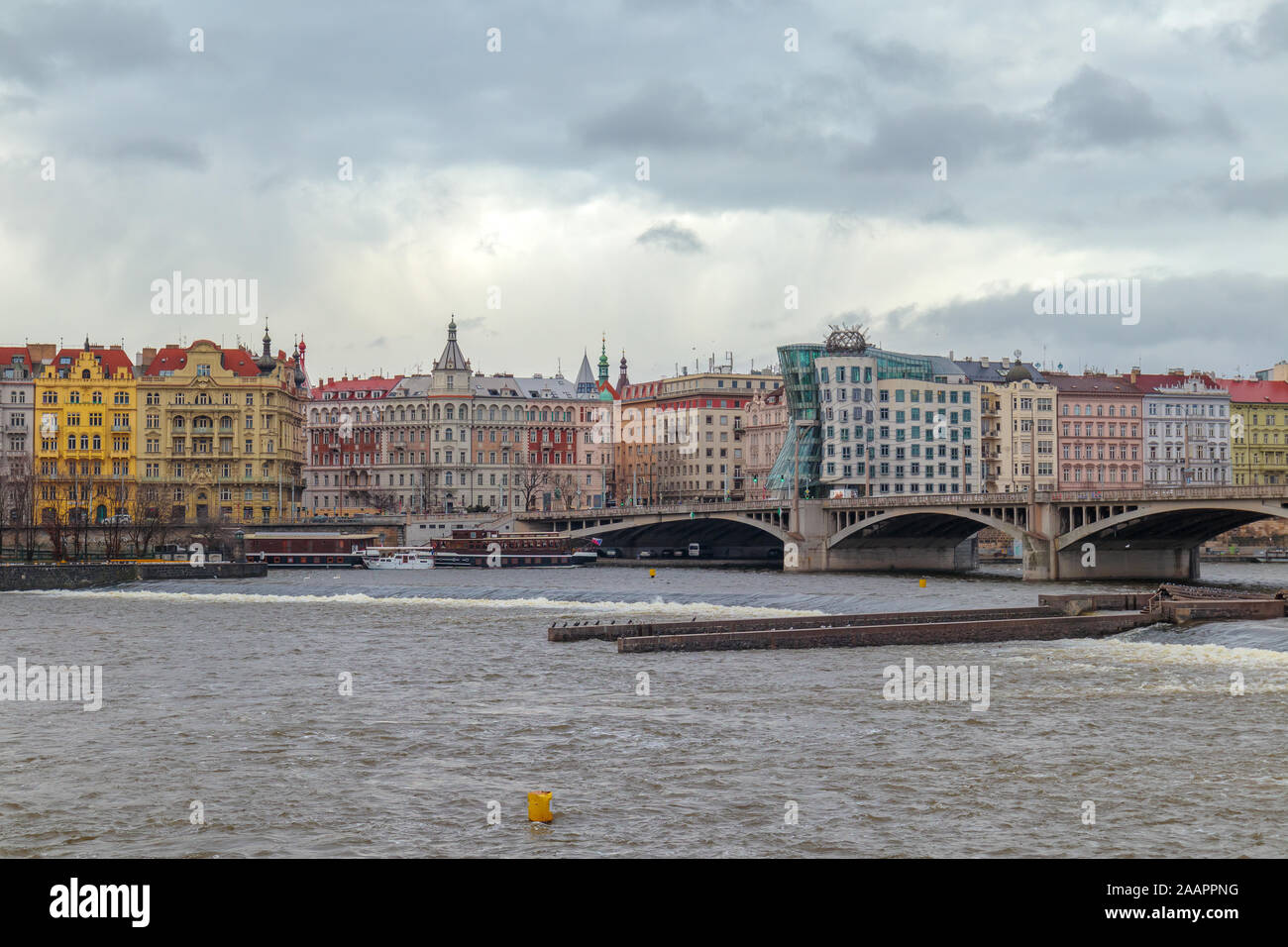 Wide view from one side of the river into prague facade in a overcast day Stock Photo