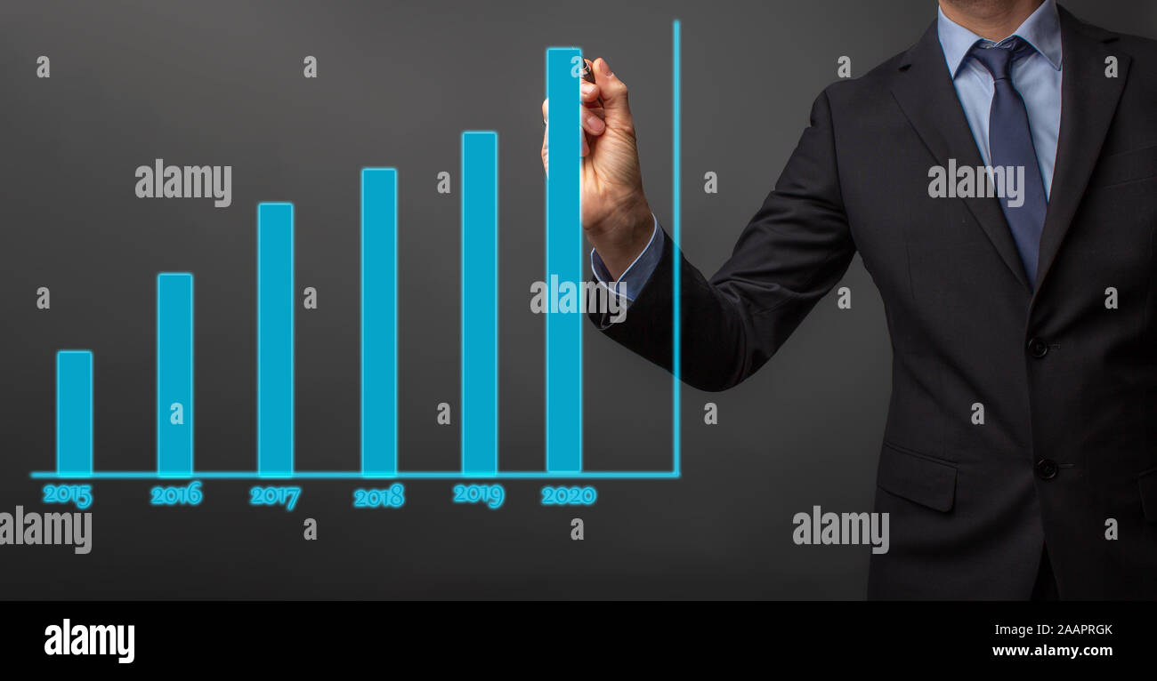 business man in suit is drawing a growth rate - anual growth rate - business decrease or inrease Stock Photo