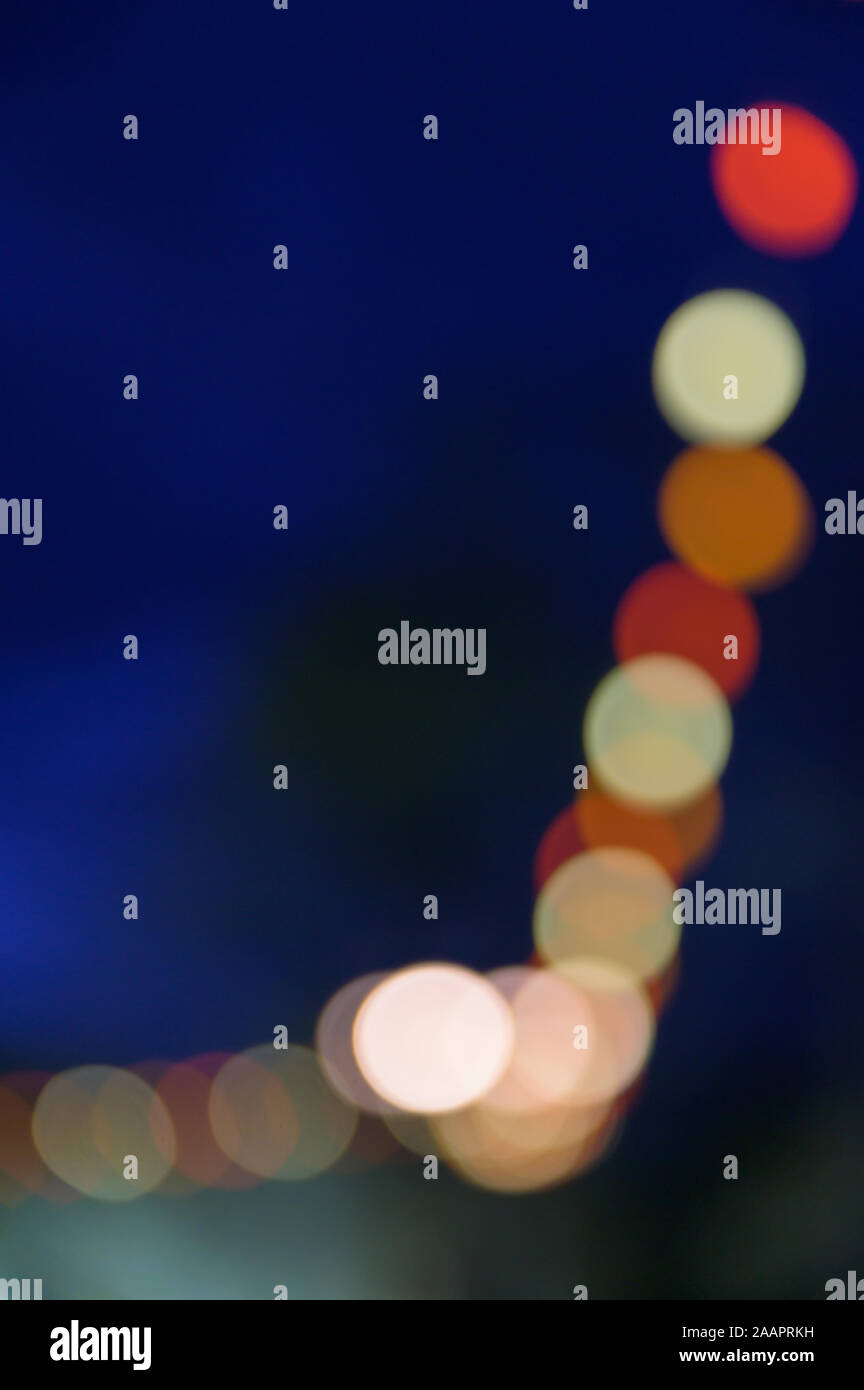 Multi-colored bokeh balls against a dark background Stock Photo