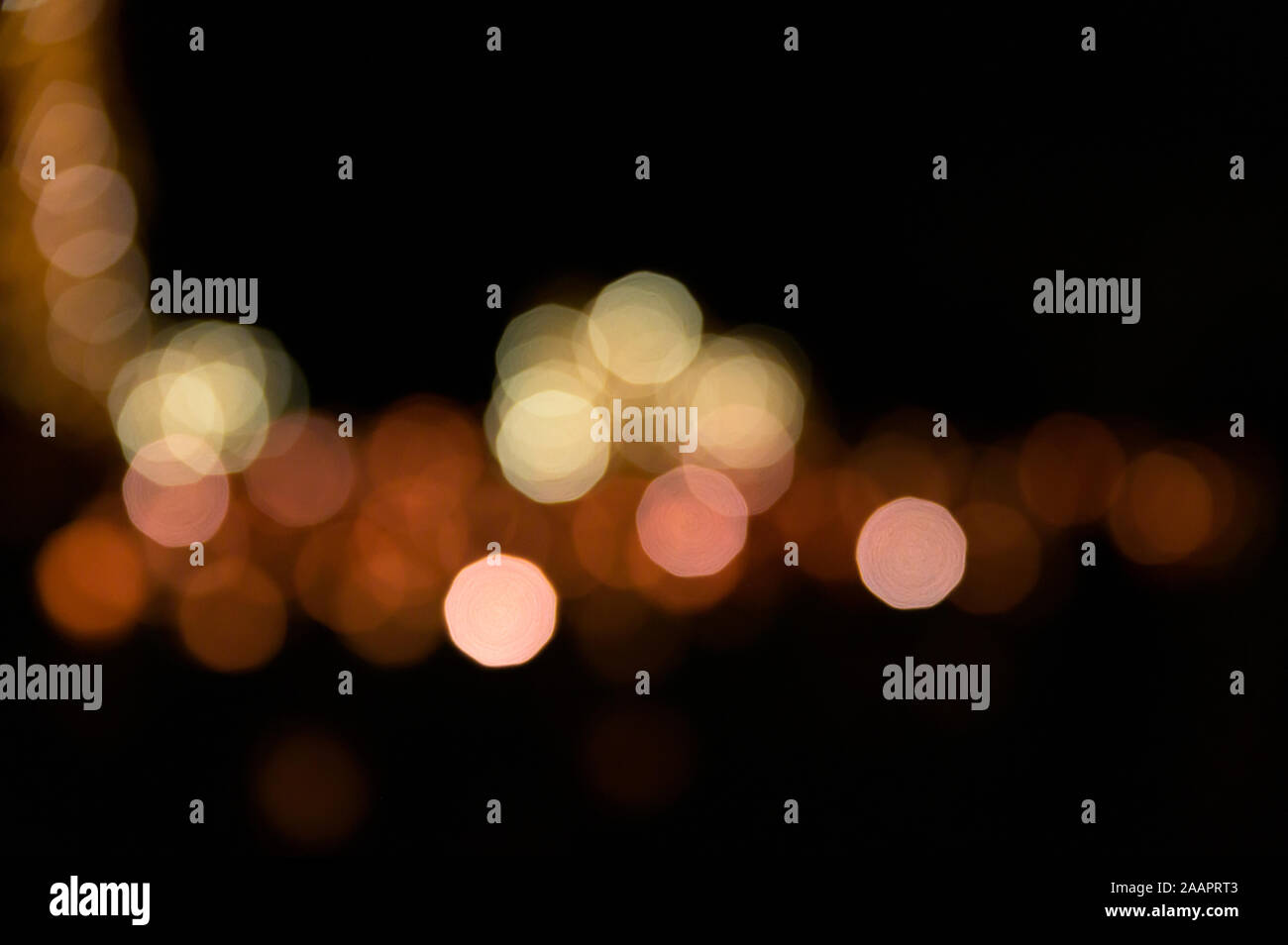 Multi-colored bokeh balls against a dark background Stock Photo