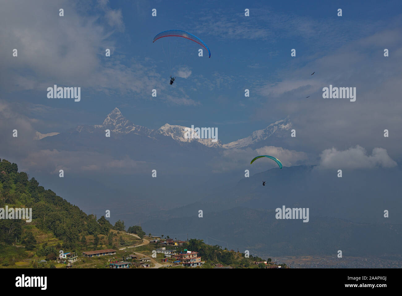 paragliding over pokhara with a view of the Annapurna range Stock Photo