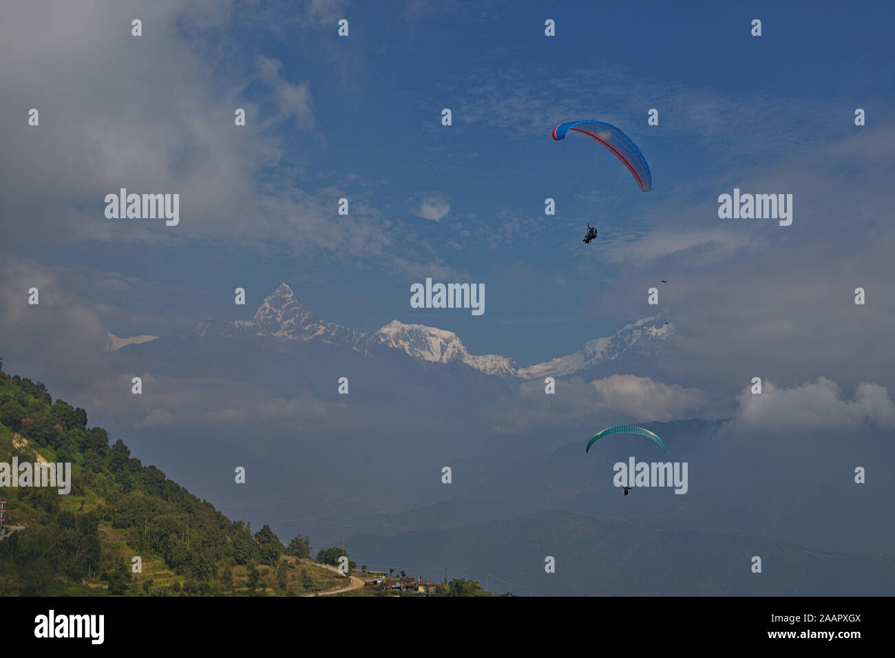 paragliding over pokhara with a view of the Annapurna range Stock Photo