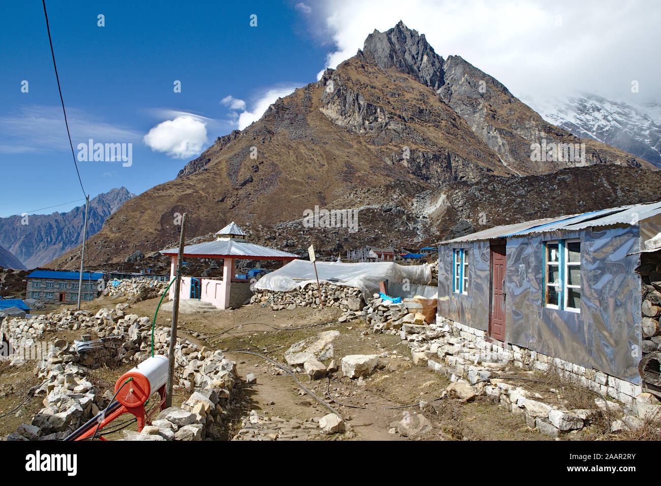 brown mountain with metal shack in foreground Stock Photo