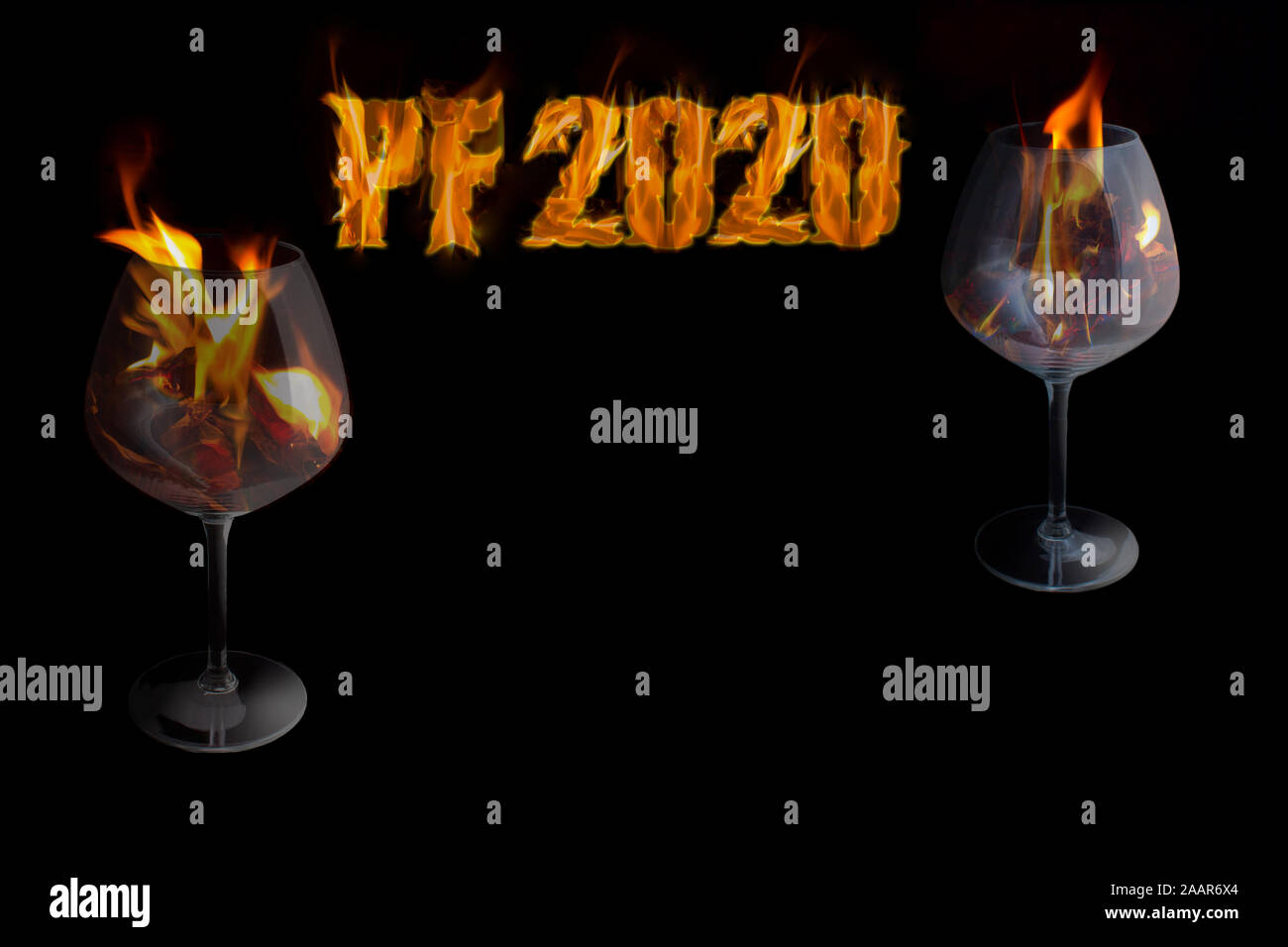 PF 2020 - happy New Year with a glasses in a fire on black background with free space for text. Stock Photo