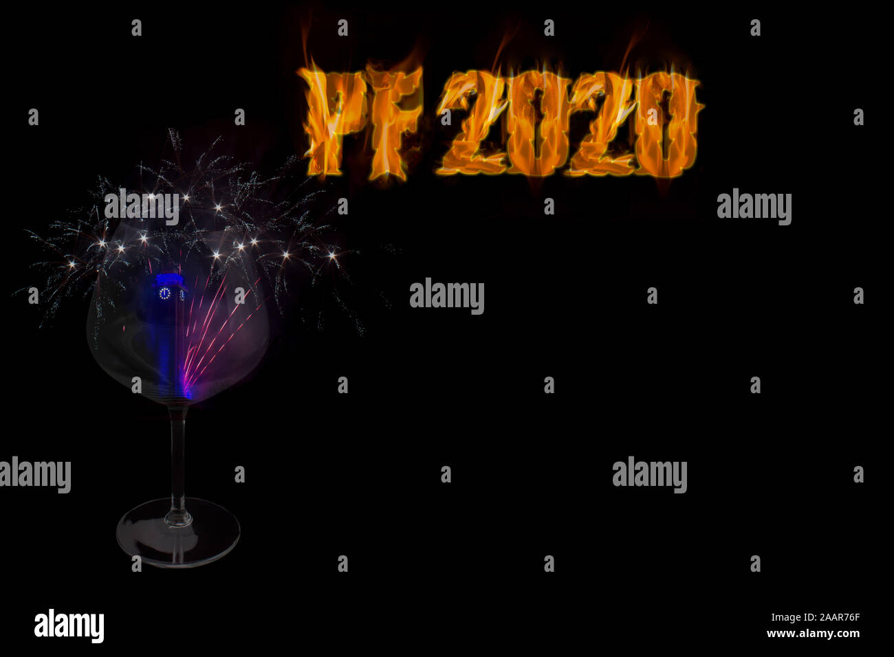 PF 2020 - happy New Year with a glass with town hall and fireworks on black background with free space for text. Stock Photo
