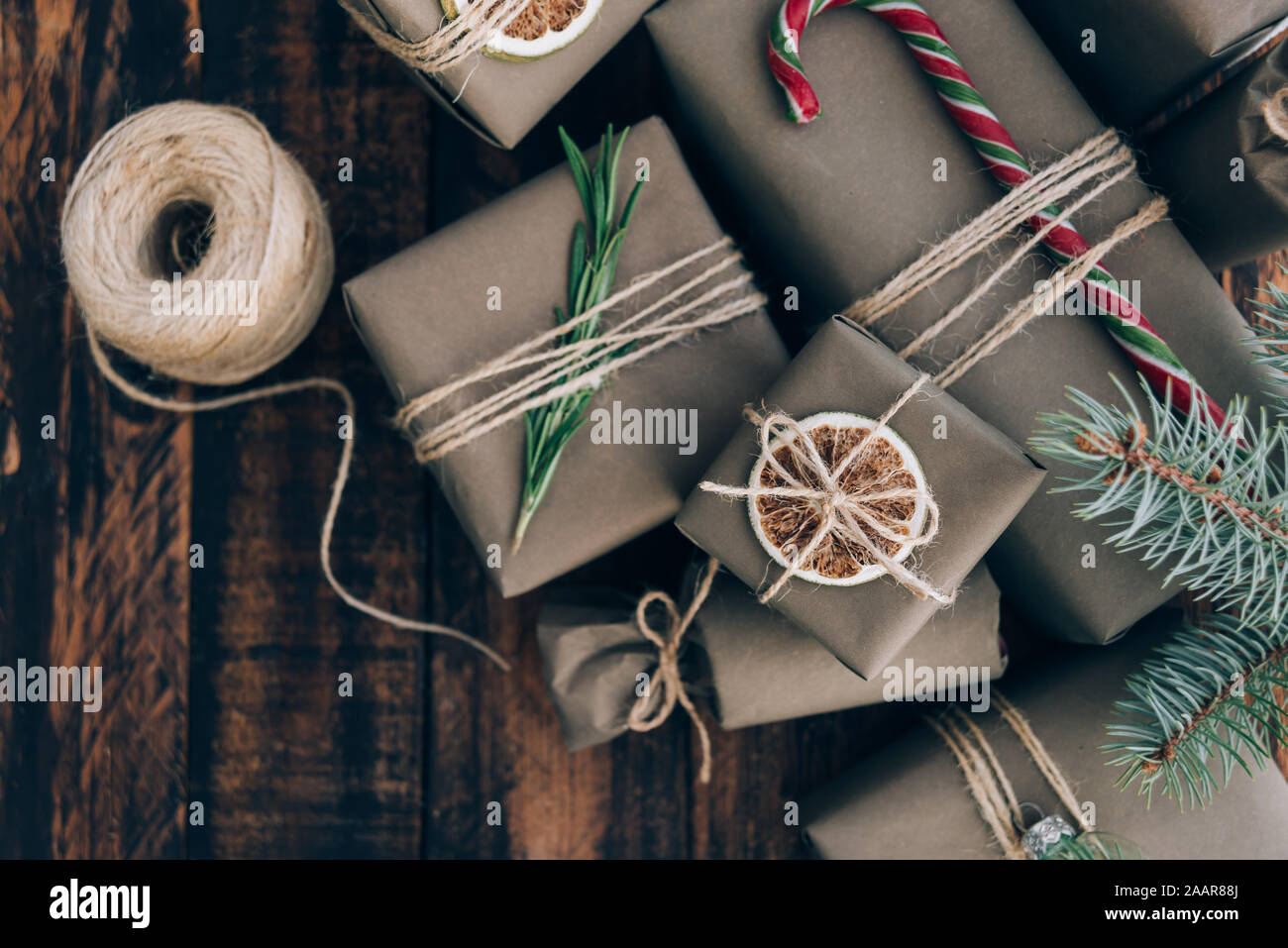 Presents and gifts wrapped in craft paper with decoration on brown ...