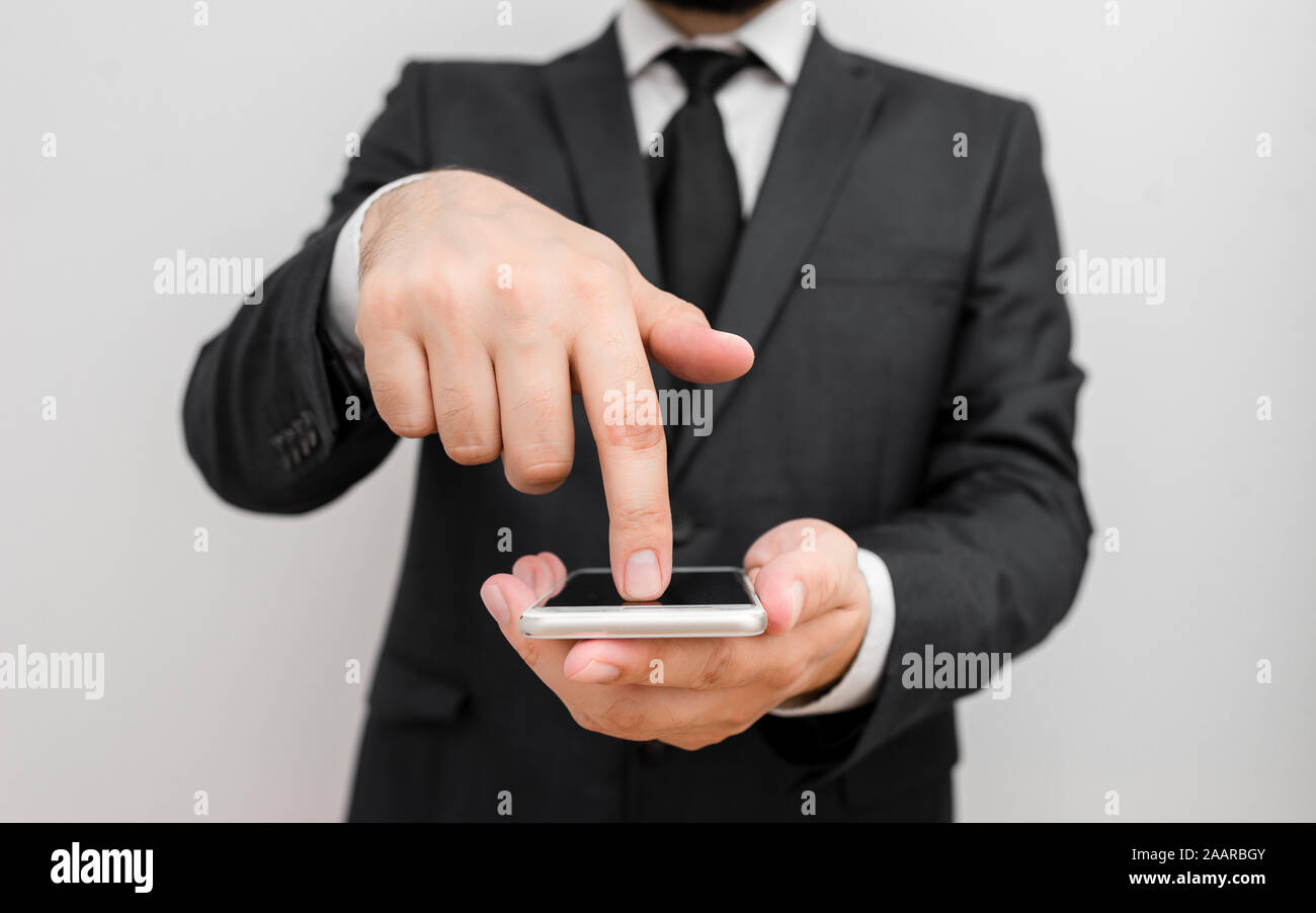Male human wear formal work suit hold smart hi tech smartphone use one ...