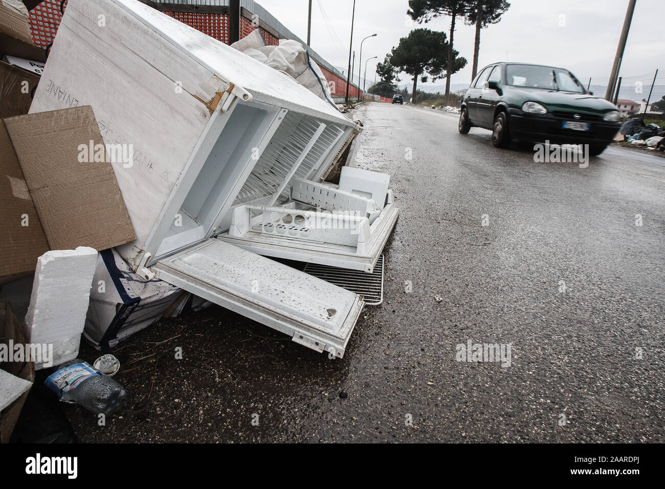 Caserta, Italy, February 21, 2008: A discarded refrigirator by the side of the road in Caserta, Italy, north of Naples during the Naples waste management crisis in 2008. Stock Photo