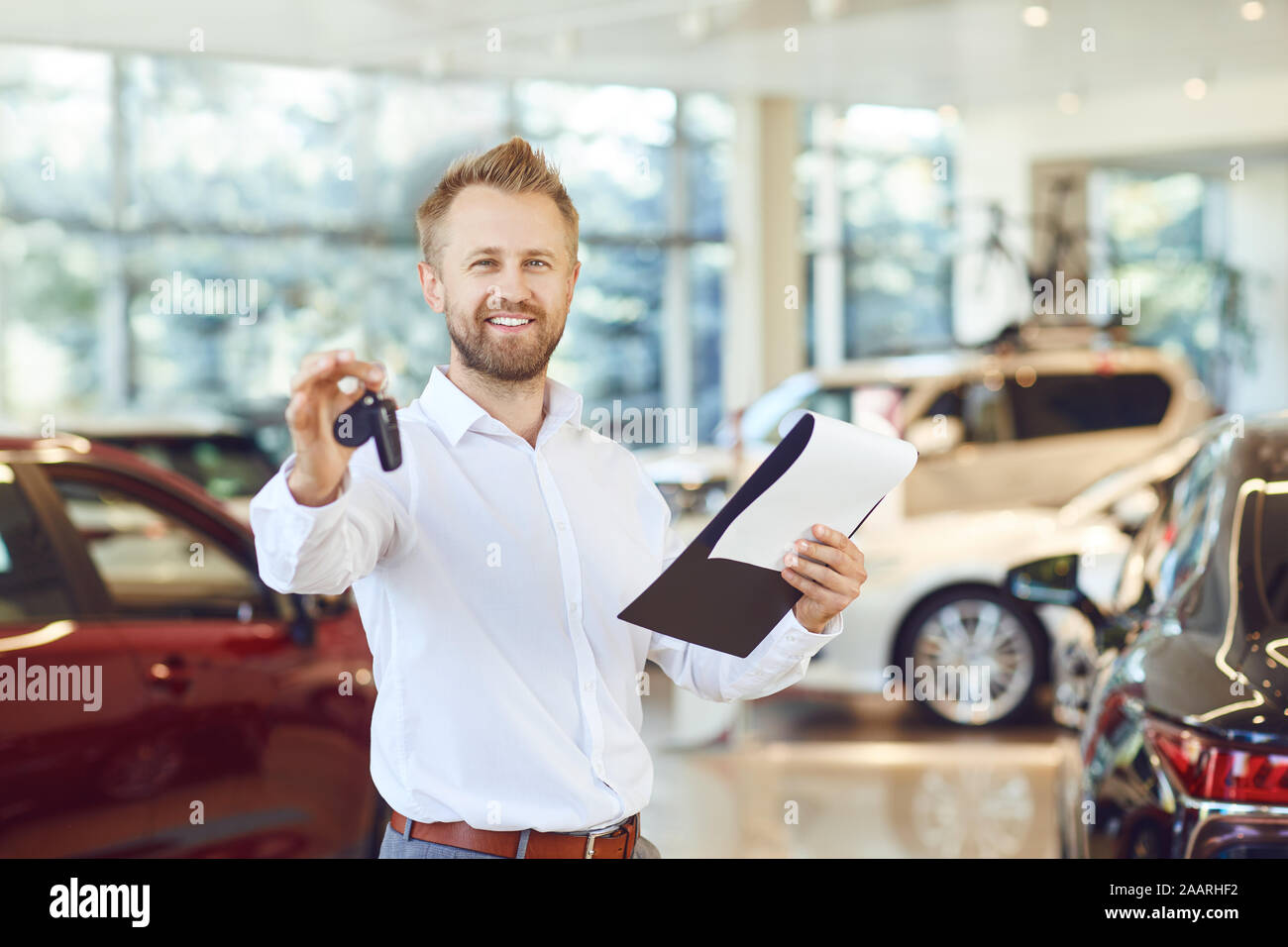 Key Car Dealership >> A Car Dealer Holding A Key In His Hand In A Showroom Stock Key Car Dealership >> A Car Dealer Holding A Key In His Hand In A Showroom Stock